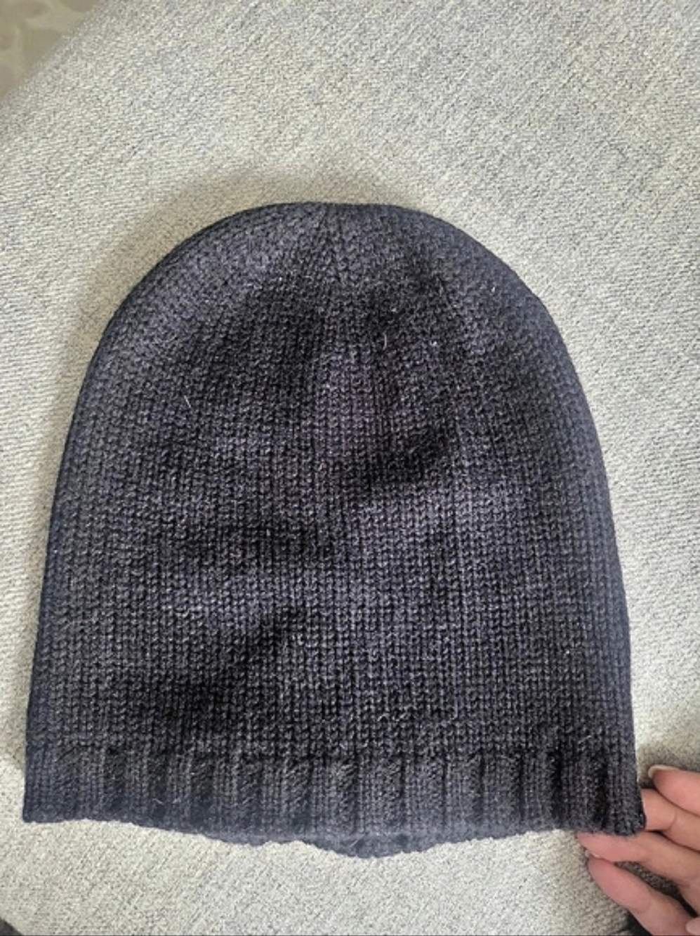 Kate Spade New York knit beanie featuring an integrated bow design at the base.
